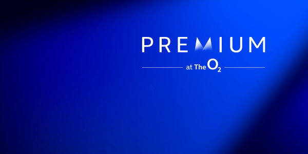  dark blue gradient background with a spotlight effect highlighting the top right corner. In the upper center, the word “PREMIUM” is displayed in bold white letters, with the “M” stylized as two triangular peaks. Below it, the text “at The O₂” is written in a smaller font with horizontal lines on either side.